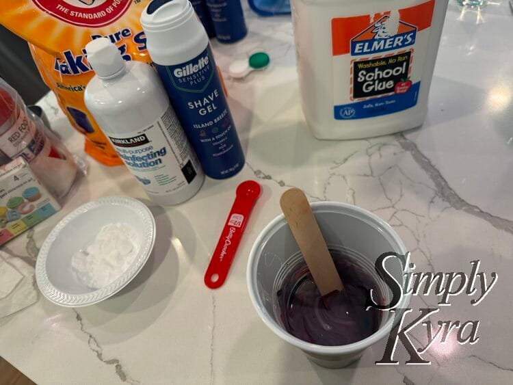 Purple glue with large wooden popsicle stick in the cup now.