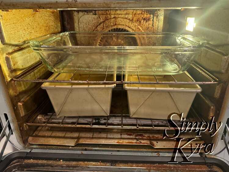 Image shows the countertop oven with a glass casserole dish on the top and two loaf pans below.