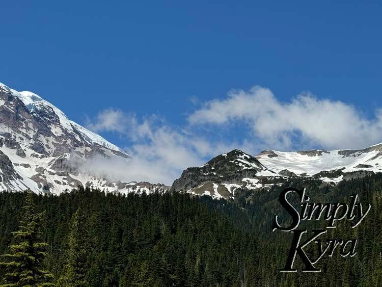 Clouds obscuring part of the snowy mountain top.