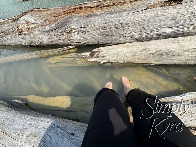 Looking down while eating at my feet above the water.